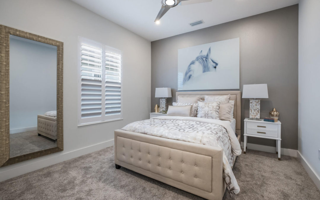 Bed in room with carpeting and horse drawing on wall