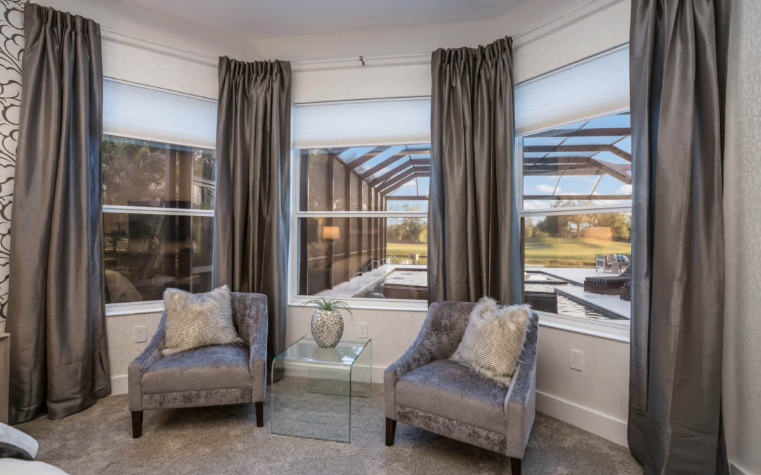 Three-window bedroom with brown curtains