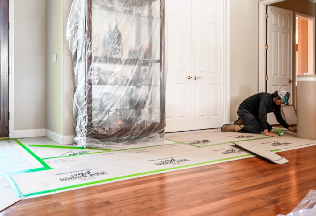 Man covering wood floor