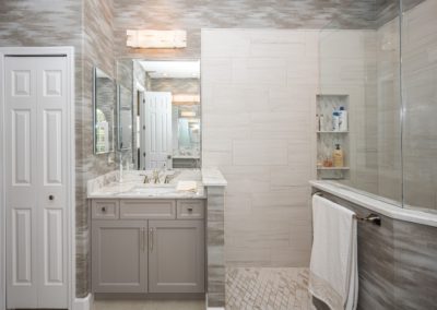 Bathroom with gray wallpaper and cabinets