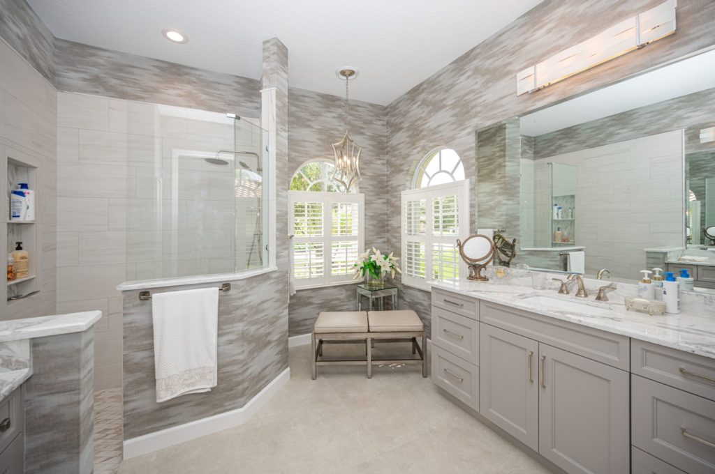 Bathroom with gray wallpaper and cabinets