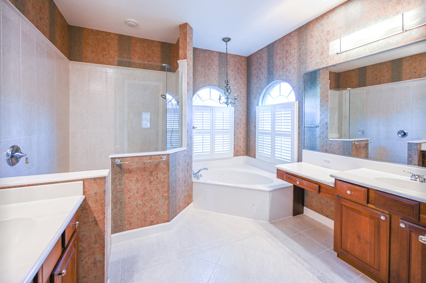 Bathroom with cherry wallpaper and cabinets