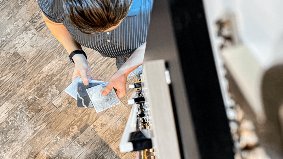 Man holding square tile samples